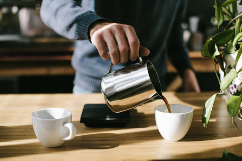 A person pouring coffee