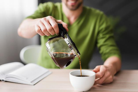 A man pouring himself a cup of coffee